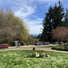 Two people in folding chairs, back to us, looking at Mt. Hood on the Horizon and gloriously clear spring day